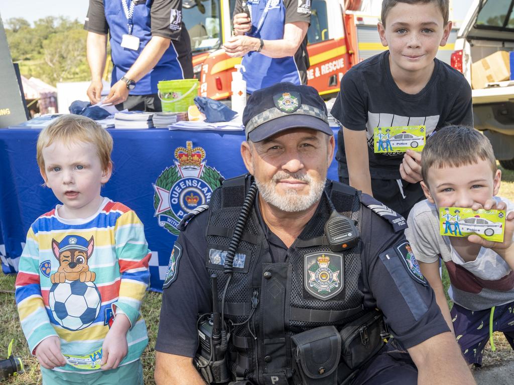 Sgt Tony Rehn with Riley Fyfe, Caleb Young and Liam Young at the Toowoomba Royal Show. Friday, March 25, 2022. Picture: Nev Madsen.