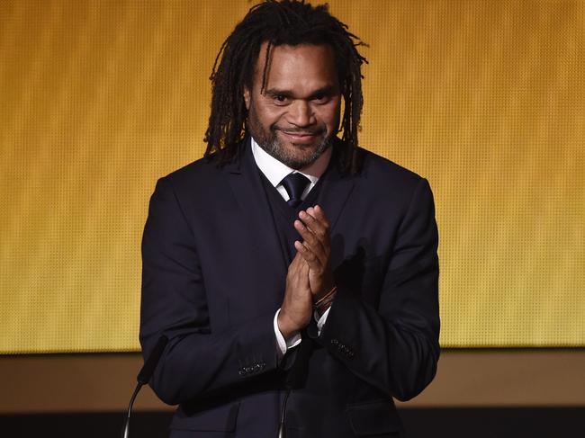 French former football player Christian Karembeu applauds on stage during the presentation of the 2014 FIFA Puskas Award for best goal during the FIFA Ballon d'Or award ceremony at the Kongresshaus in Zurich on January 12, 2015. AFP PHOTO / OLIVIER MORIN