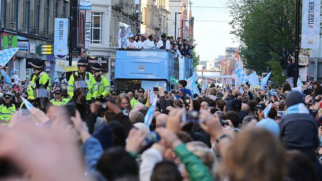 Manchester City's English goalkeeper Joe Hart holds up the Premiership Trophy.