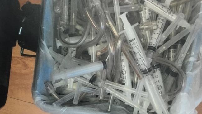 A bin of syringes found in the surgery.