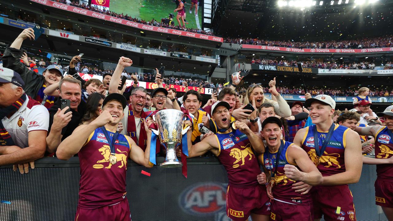 Brisbane Lions players celebrate with fans after winning the AFL Grand Final, defeating the Sydney Swans at the MCG. Picture Lachie Millard