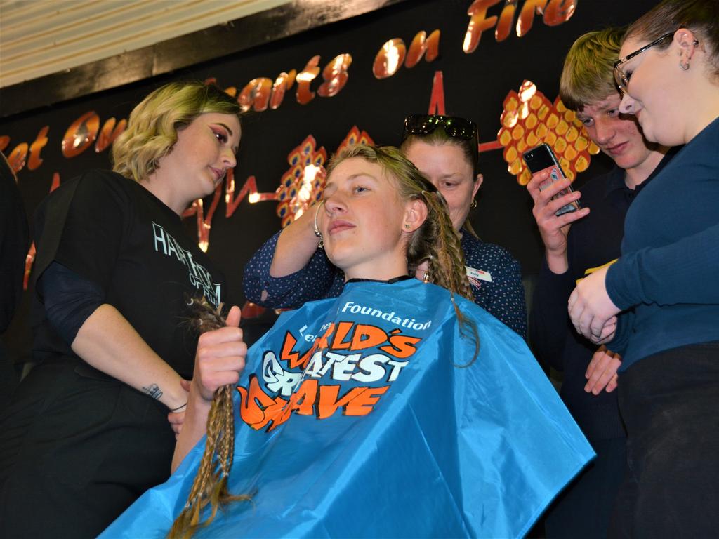 At the St Joseph's College 2023 World's Greatest Shave event is student Emily Chandler getting her hair cut by her support crew and hairdresser Natalie Schmidt from the Hair Room on Russell. Picture: Rhylea Millar