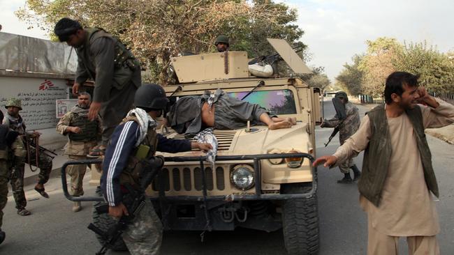 Afghan security forces take a wounded civilian man to the hospital after Taliban attack in Kunduz city.