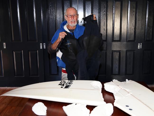 Rowland still has his ruined surfboard and wetsuit. Picture: Peter Lorimer