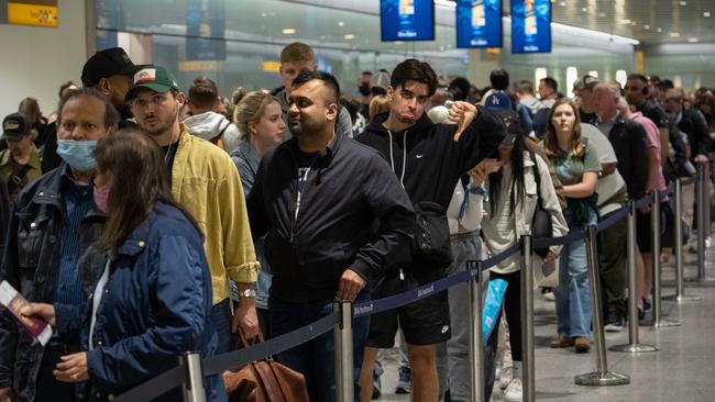 Travellers wait in a long queue to pass through the security check at Heathrow in June. Picture: Getty Images