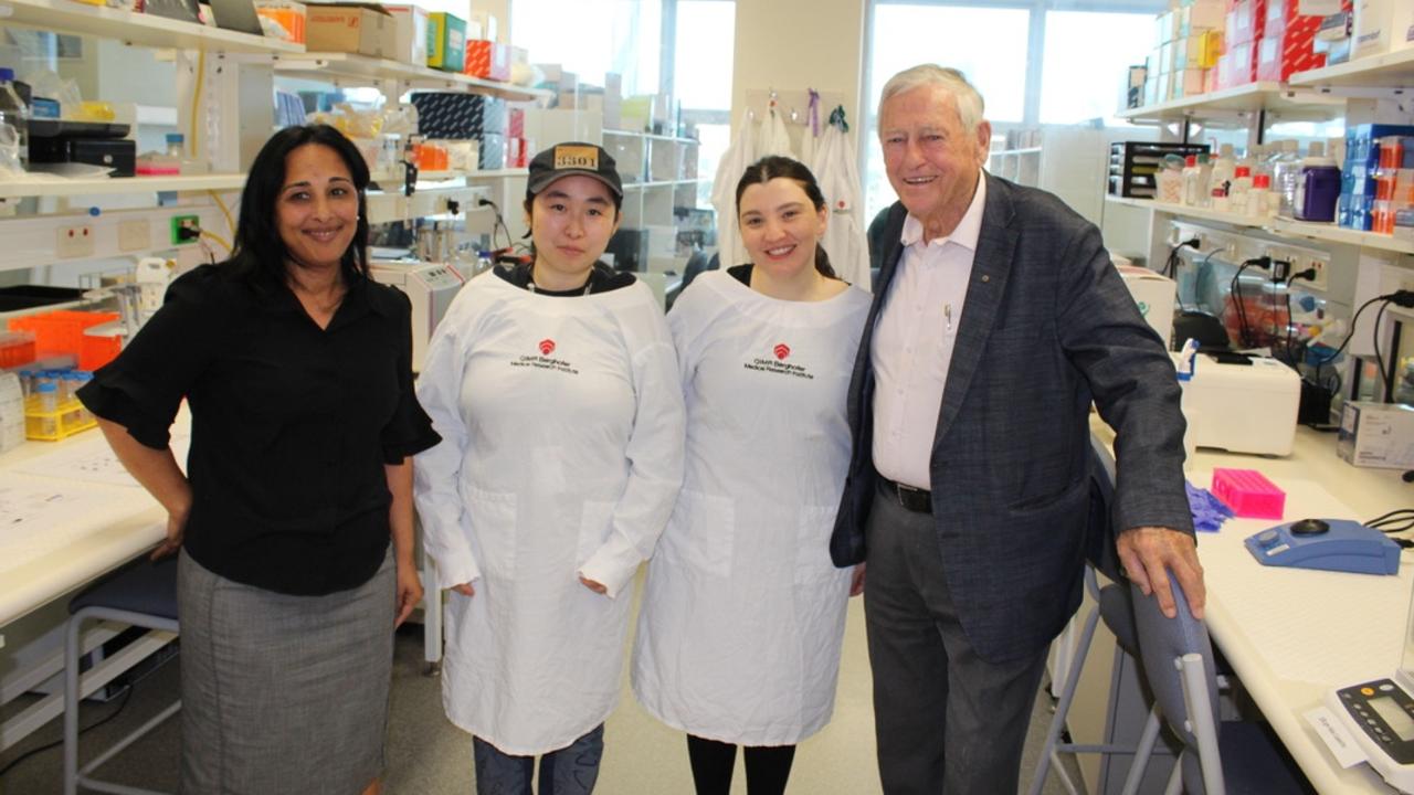 Mr Berghofer (right) with senior researcher and head of QIMR Berghofer's Gene Regulation and Translational Medicine Group, Professor Sudha Rao (left) and other researchers who have been focused on the development of the new Covid-19 drugs.