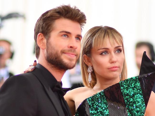 Miley Cyrus (R) and Liam Hemsworth arrive for the 2019 Met Gala at the Metropolitan Museum of Art on May 6, 2019, in New York. - The Gala raises money for the Metropolitan Museum of Art’s Costume Institute. The Gala's 2019 theme is “Camp: Notes on Fashion" inspired by Susan Sontag's 1964 essay "Notes on Camp". (Photo by ANGELA  WEISS / AFP)