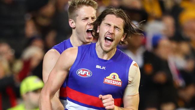 Marcus Bontempelli and Lachie Hunter celebrate a goal against Hawthorn.