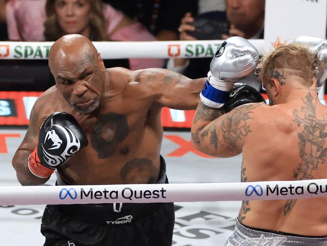 ARLINGTON, TEXAS - NOVEMBER 15: Mike Tyson (L) punches Jake Paul during their heavyweight bout at AT&T Stadium on November 15, 2024 in Arlington, Texas. (Photo by Christian Petersen/Getty Images)