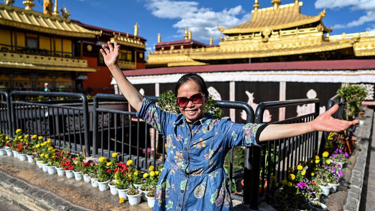 Tourist posing for a picture at Jokhang Temple in the regional capital Lhasa, in China's Tibet Autonomous Region. Picture: Hector Retamal/AFP