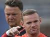 Manchester United's Wayne Rooney, left, talks with Jonny Evans as manager Louis van Gaal, left, watches during training for the their 2014 Guinness International Champions Cup soccer match against Real Madrid at Michigan Stadium in Ann Arbor, Mich., Friday, Aug. 1, 2014. (AP Photo/Paul Sancya)