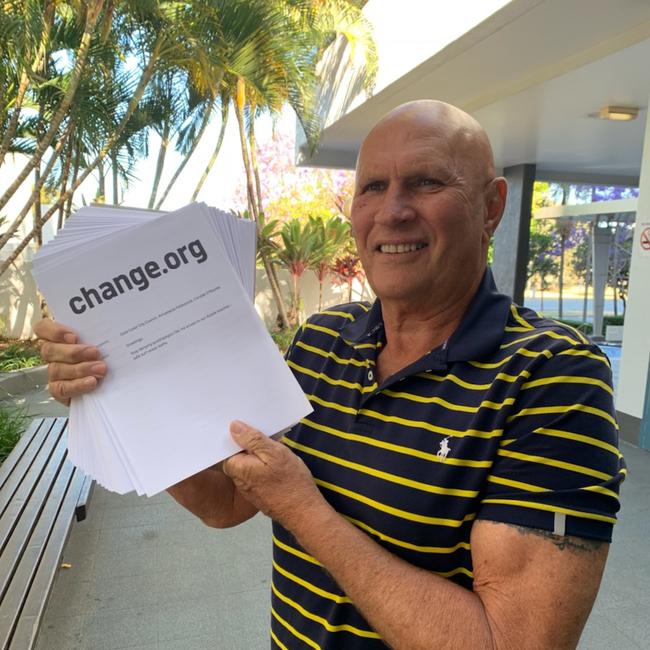 Surfers Paradise identity Billy James with a petition calling for ocean pools to be installed on the Gold Coast. Picture: Ryan Keen