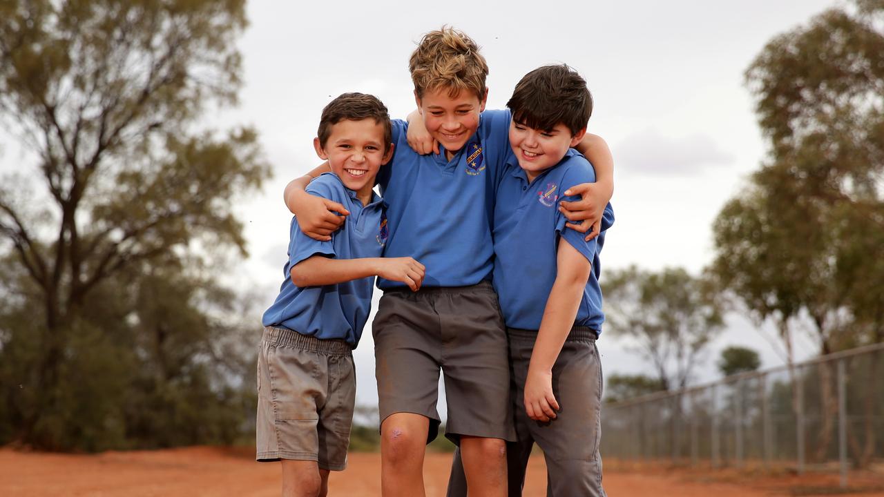 Jayden Smith, 10, Will Mudford, 12, and Mac Lawson, 9, on the dirt road next to the school that they use to train for the upcoming cross country. Picture: Jonathan Ng