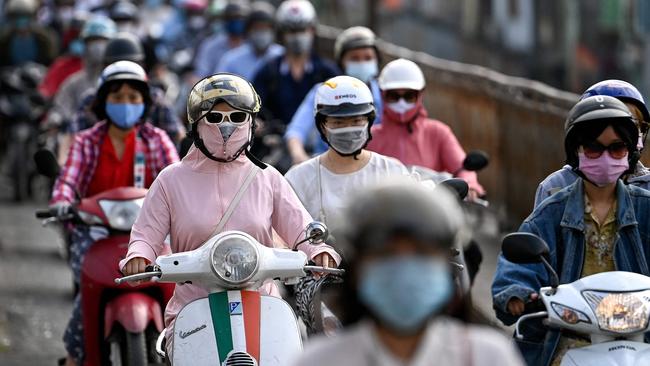 Morning commuters wearing face masks, amidst concerns about the Covid-19 coronavirus, in Hanoi. Picture: AFP