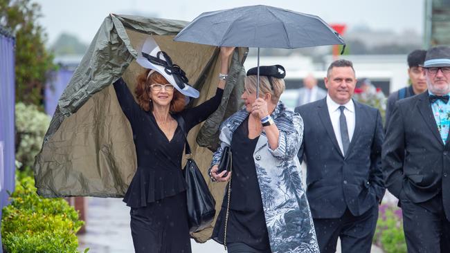 Racegoers braved the wet weather at Flemington’s Derby Day on Saturday. Picture: Jay Town