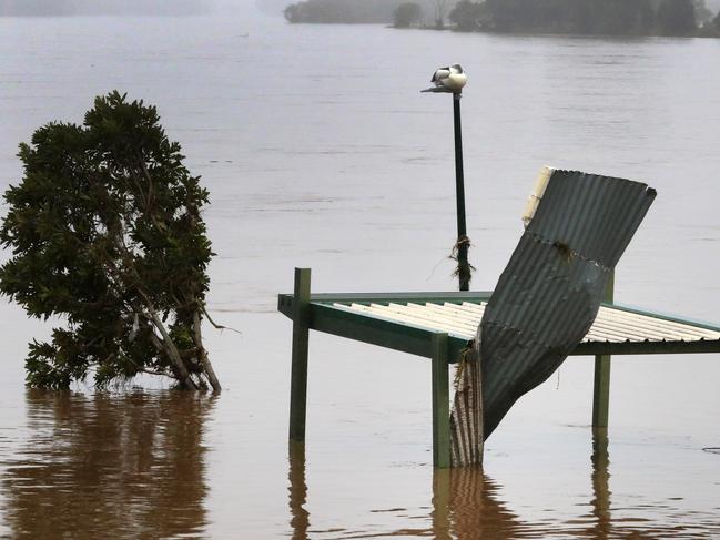 Floodwaters are seen in and around Taree on the mid-north coast of NSW as torrential rain inundates the region, cutting off communities with NSW SES crews winching people to safety from rooftops and surging rivers. Picture: NewsWire / Scott Calvin