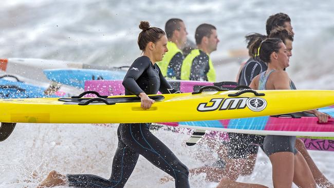 Ironwoman Lizzie Welborn (left) during a training session on Newport Beach for the Coolangatta Gold.