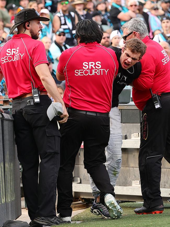 Security remove a teenage pitch invader during the Port Adelaide v Richmond match at Adelaide Oval. (Photo by Sarah Reed/AFL Photos via Getty Images)