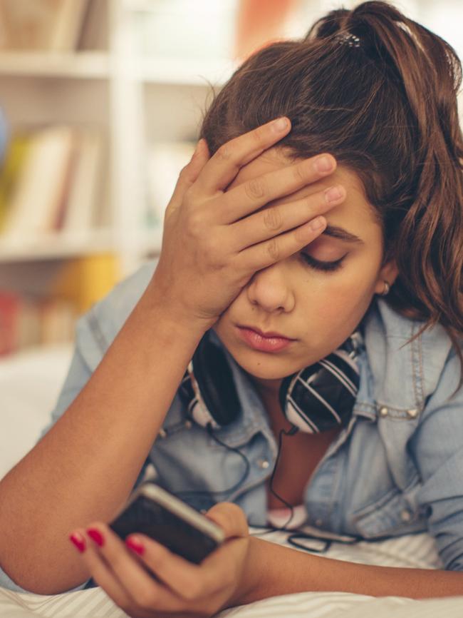 Teenage girl checking smart phone