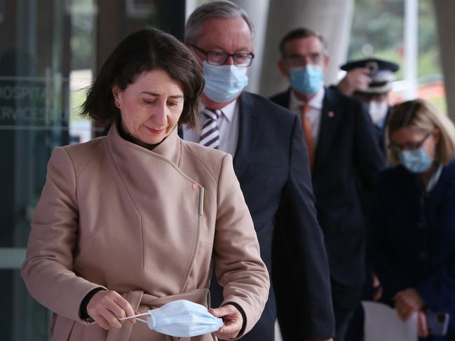 SYDNEY, AUSTRALIA - JULY 14: NSW Premier Gladys Berejiklian arrives at a press conference on July 14, 2021 in Sydney, Australia. NSW Premier Gladys Berejiklian has announced an extension to the current lockdown restrictions for at least a further two weeks. NSW recorded 97 cases of community transmission in the 24 hour reporting period until 8pm on Tuesday evening. Of those cases, 24 were infectious in the community. Lockdown restrictions remain in place across Greater Sydney, the Blue Mountains, the Central Coast and Wollongong with all residents subject to stay-at-home orders. People are only permitted to leave their homes for essential reasons, including purchasing essential goods, accessing or providing care or healthcare, work, education and exercise within a 10km radius from home or within the local government area, and with a maximum of two people per group. Browsing in shops is prohibited and only one person per household can leave home for shopping per day. Outdoor public gatherings are limited to two people, while funerals are limited to 10 people only.  (Photo by Lisa Maree Williams/Getty Images)