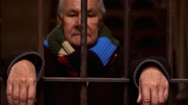 Noel Tovey, at the D Division gate, wrote of his Pentridge experiences in two autobiographies. Picture: Rupert Mann.