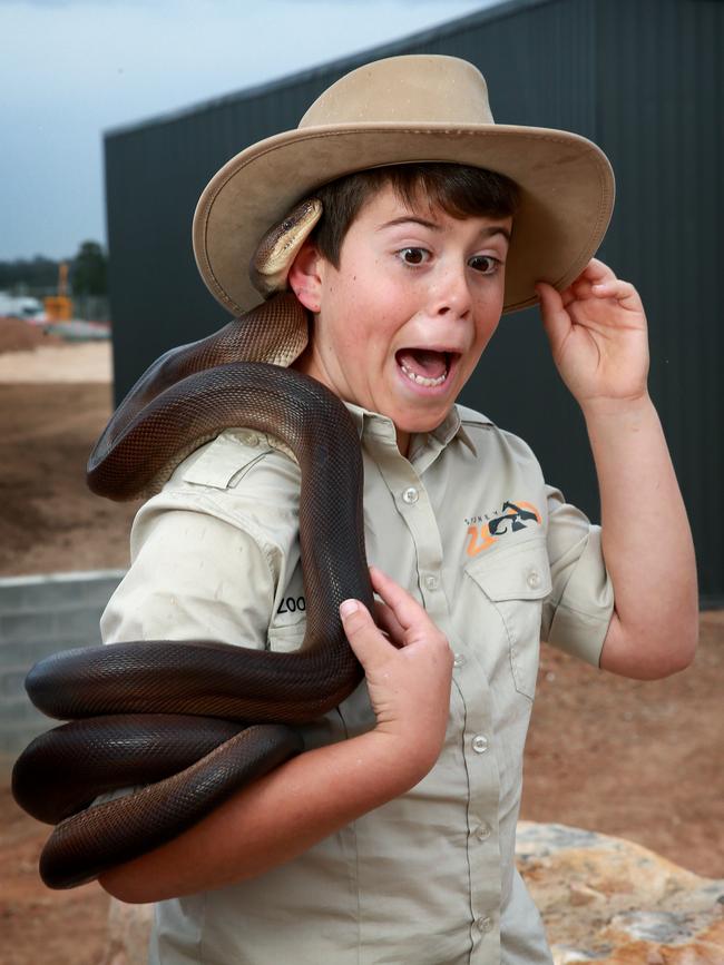 Harrison Meek, 11, was a little nervous to hold the python. Picture: Toby Zerna