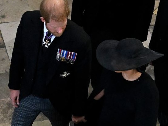 Meghan Markle and Prince Harry holding hands at Queen Elizabeth’s funeral. Picture: Gareth Cattermole/Getty Images