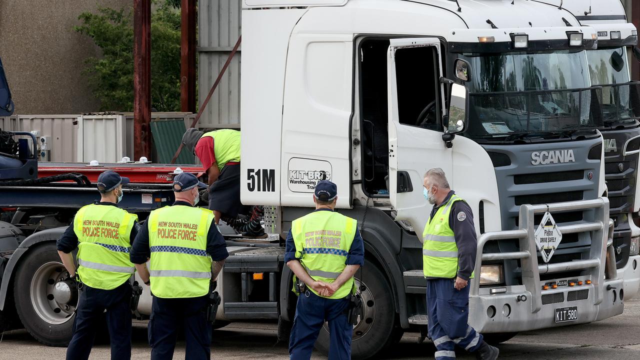 NSW Police and Transport NSW officers raid the truck depot of Kit Bros transport company in Liverpool after the smuggling. Picture: Toby Zerna