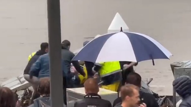 Howard Smith Wharves workers pull a man from a flooded Brisbane River. Picture: Matt Toomey