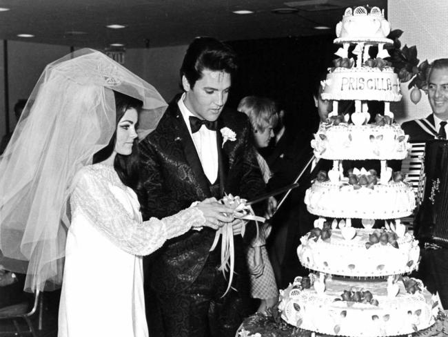 Elvis Presley and Priscilla cut their wedding cake after exchanging nuptials in the Aladdin Hotel-Casino in Las Vegas.