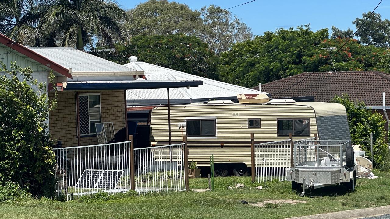 Police are conducting investigations inside a Mackay home with an old 70s style caravan, box trailer, in front yard and a pram at the front of the home on the porch. Picture: Heidi Petith