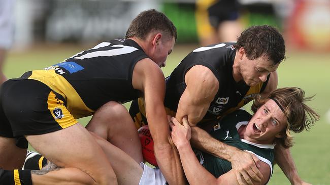 Echuca’s Matt Lias is tackled by Rochester players Grant Fuller and Lachlan Harper in the match it was found he was ineligible to play in. Picture: Yuri Kouzmin