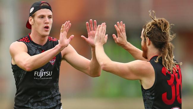 MELBOURNE, AUSTRALIA - FEBRUARY 19: Sam Grimley of the Bombers celebrates with Nick Kommer after kicking a goal during the Essendon Bombers AFL Intra-Club match at True Value Solar Centre on February 19, 2016 in Melbourne, Australia. (Photo by Scott Barbour/Getty Images)