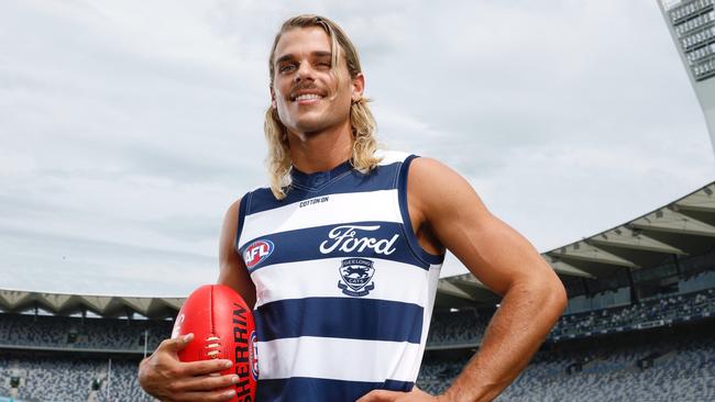 AFL star Bailey Smith proudly dons his new Geelong Cats jersey at GMHBA Stadium after being traded from the Western Bulldogs on Wednesday night. Picture: Michael Klein.