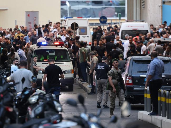 Ambulances are surrounded by people at the entrance of the American University of Beirut Medical Center, on September 17, 2024, after explosions hit locations in several Hezbollah strongholds around Lebanon amid ongoing cross-border tensions between Israel and Hezbollah fighters. Hundreds of people were wounded when Hezbollah members' paging devices exploded simultaneously across Lebanon on September 17, in what a source close to the militant movement said was an "Israeli breach" of its communications. (Photo by Anwar AMRO / AFP)