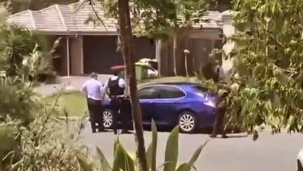 Screenshots of a video taken by a Pimpama resident showing police in her street.