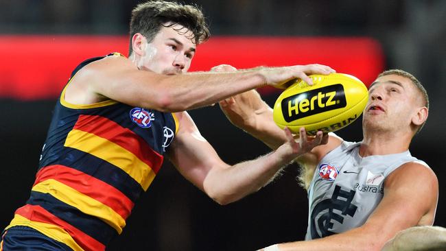 Mitch McGovern of the Crows outmarks Liam Jones of the Blues during the round 7 clash at Adelaide Ova. Picture: AAP Image/David Mariuz