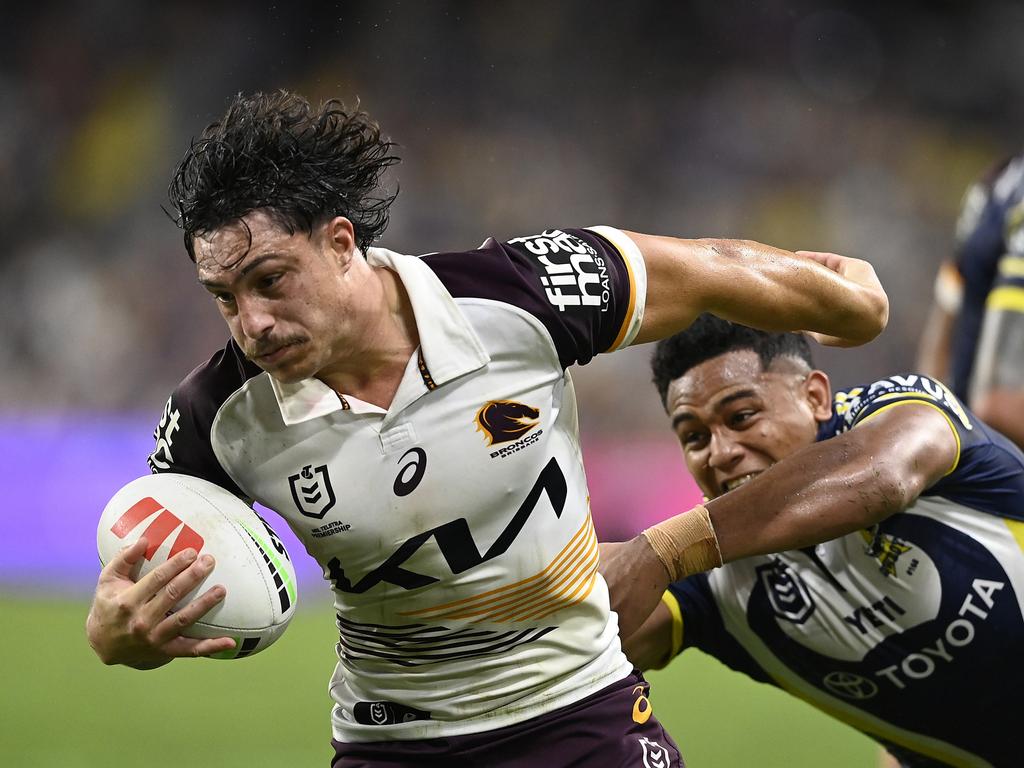 Kotoni Staggs of the Broncos is tackled during the round 23 NRL match. (Photo by Ian Hitchcock/Getty Images)