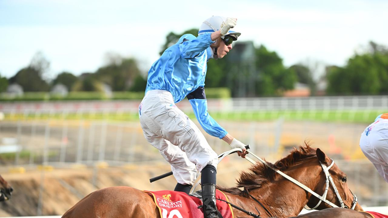 Michael Dee salutes after winning the Caulfield Cup. Picture: Vince Caligiuri-Getty Images