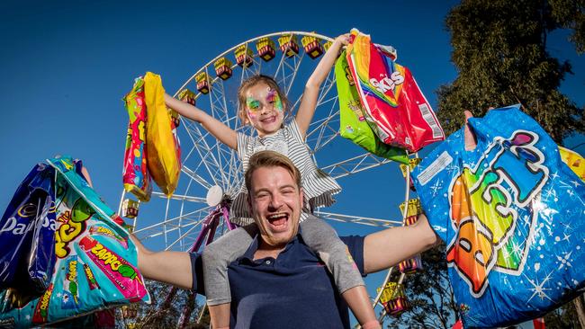 Royal Melbourne Show. Josh Carey and his niece Olivia Kolaitis, 7, load up with showbags. Picture: Jake Nowakowski