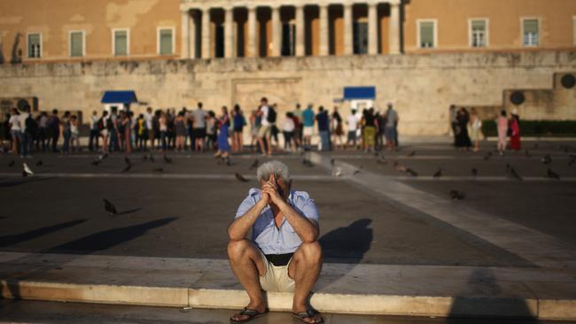 ATHA man sits alone with his thoughts as protesters gather outside the Greek parliament to demonstrate against austerity after an agreement for a third bailout with eurozone leaders.