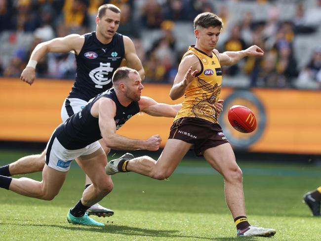 Sam Butler kicks at goal while being tackled by Sam Docherty in July 2023. Picture: Michael Klein.