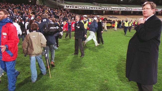 Then AFL chief executive Wayne Jackson on the MCG with fans after the scoreboard fire.