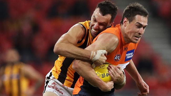 An unrewarded tackle by Hawk Jonathon Ceglar on Giant Jeremy Cameron. Picture: Mark Kolbe/Getty Images