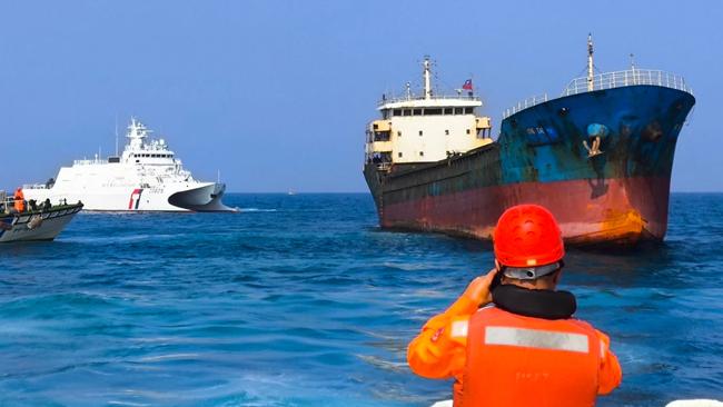 Taiwanese coast guard vessels on Tuesday prepared to board a cargo ship suspected of severing an undersea cable. Picture: Handout / Taiwan Coast Guard/AFP