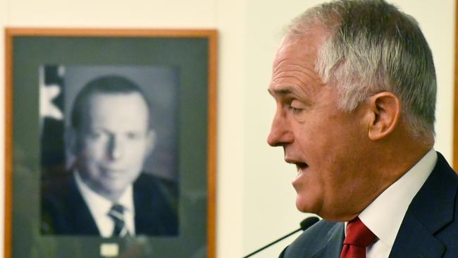 Malcolm Turnbull speaks in front of a portrait of former prime minister Tony Abbott at Parliament House in 2017. Picture: AAP