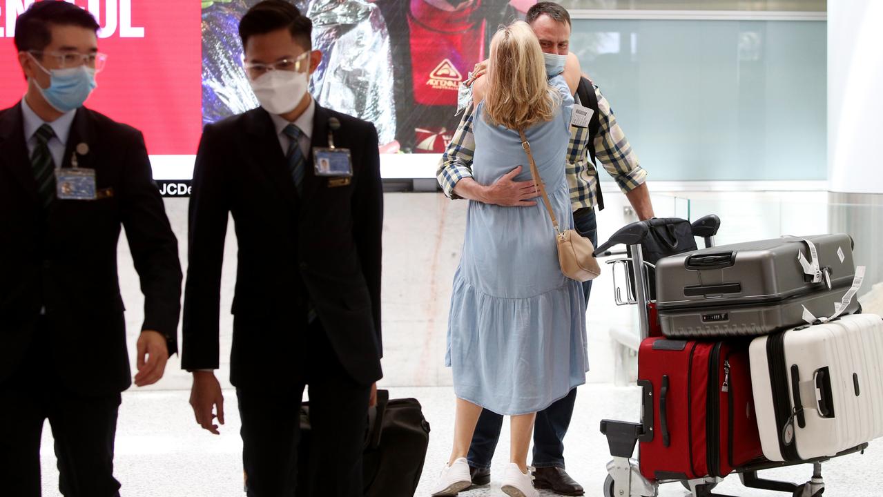 A couple reuniting at Sydney International Airport on Monday, the first day fully vaccinated international travellers no longer had to quarantine in NSW. Picture: Lisa Maree Williams / Getty Images