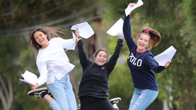 Eighteen year old triplets Jordan, Erin and Keely Plymin with their VCE results. Picture: Alex Coppel.