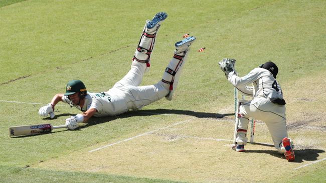 Pat Cummins dives into his crease as BJ Watling knocks off the bails. Picture: Getty Images