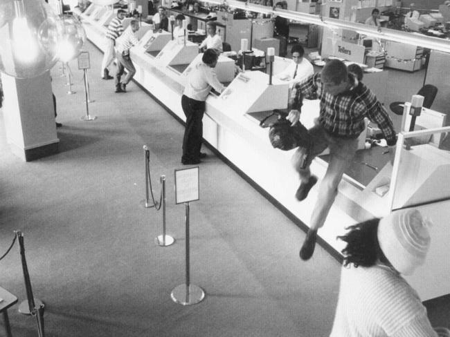 A bandit leaps a bank counter in a Westpac Bank in Canberra in 1996.